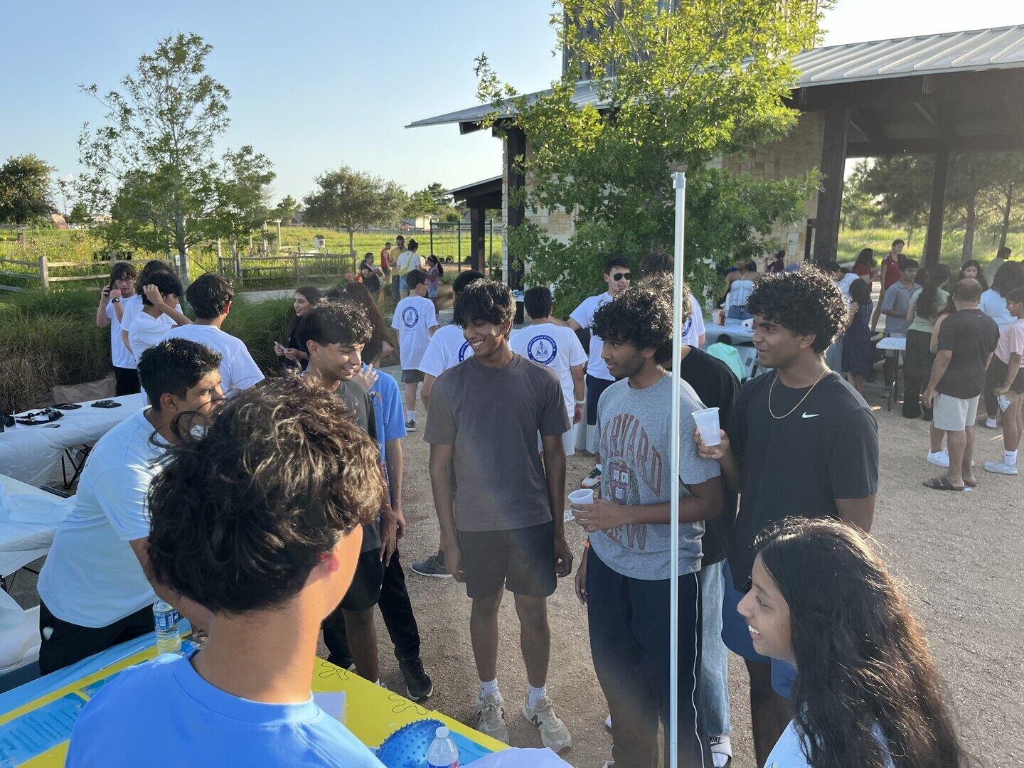 ReEnvision members and visitors talking at an outdoor community event